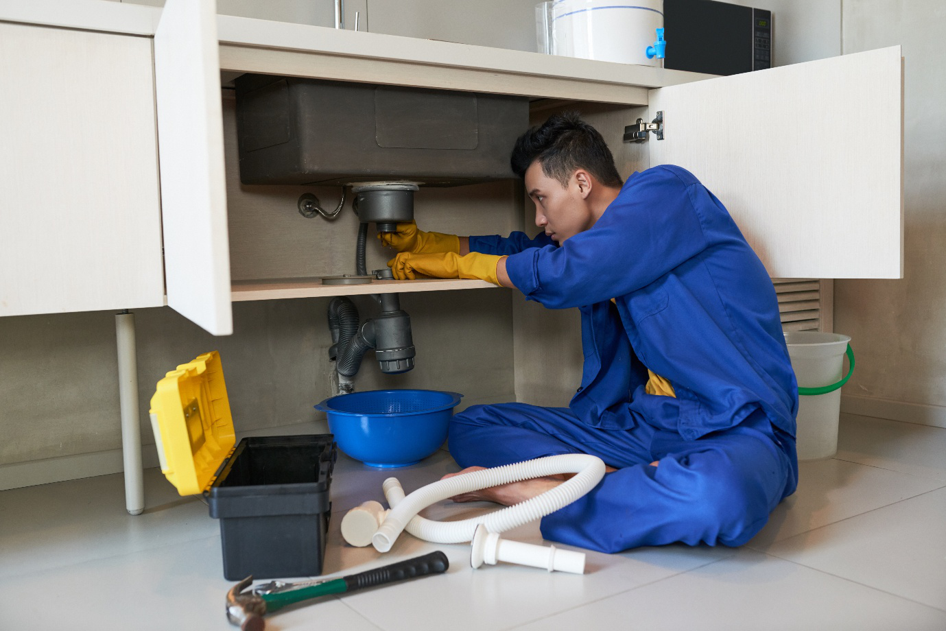 A plumber replacing drain pipes.