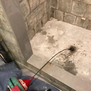 Drain cleaning being performed with an auger