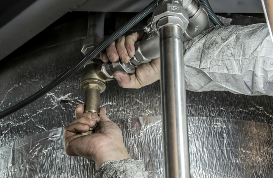 Licensed plumber replacing old galvanized pipes with modern piping