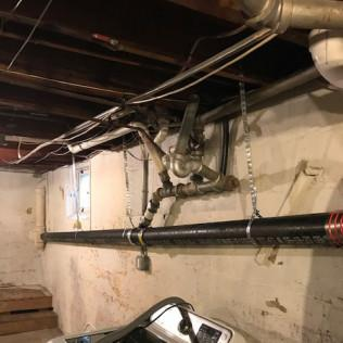 Close-up of old galvanized pipes with visible rust and corrosion