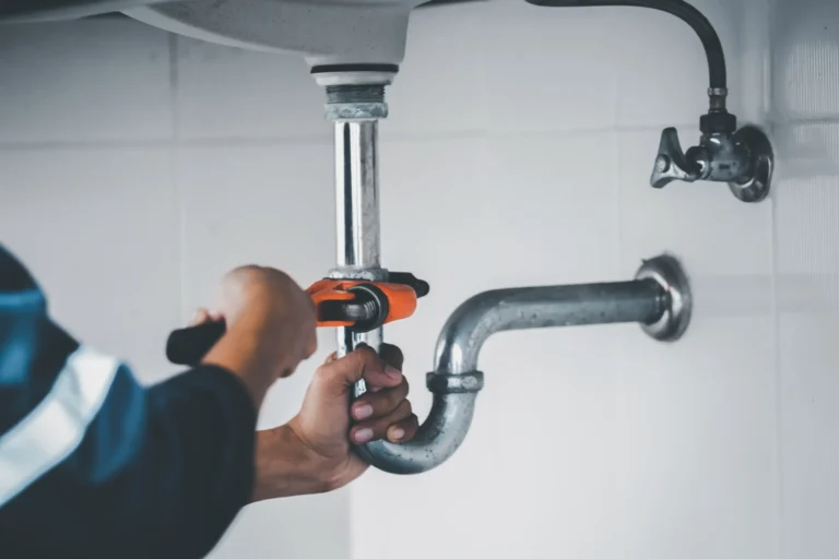 A professional plumber unclogging a residential drain