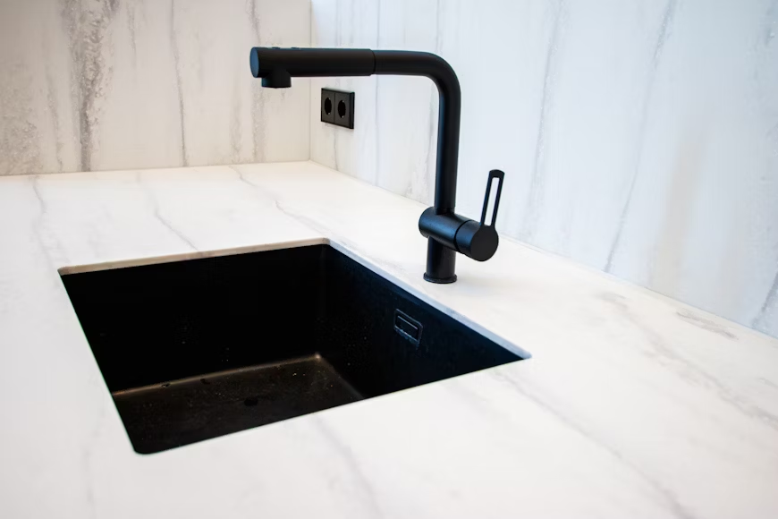 A black sink and faucet