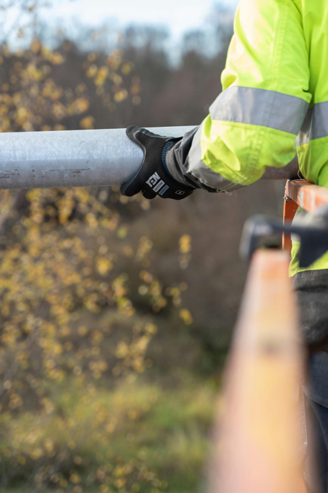 Plumber inspecting pipes for blockages inside a commercial property
