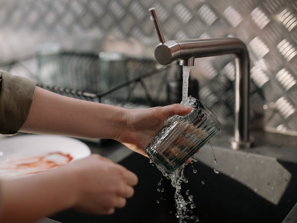  A person washing a glass
