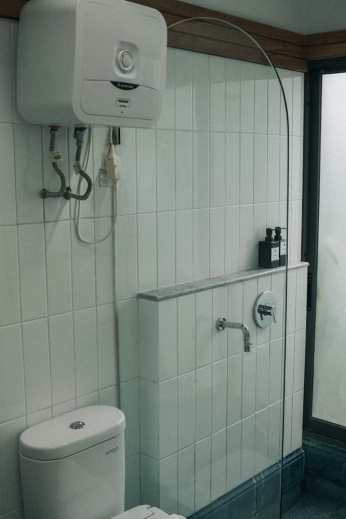Commercial bathroom with toilet and walk-in shower