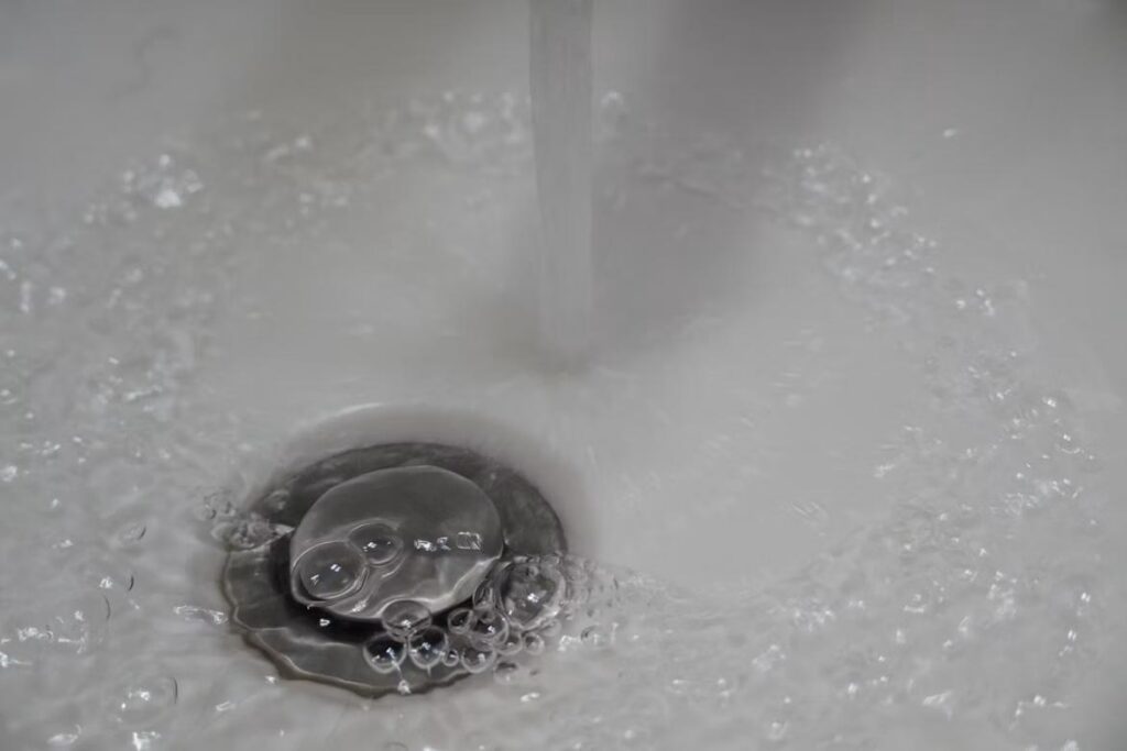 Plumbers identify slow drainage as an early warning sign of potential sewer line blockage or system deterioration
