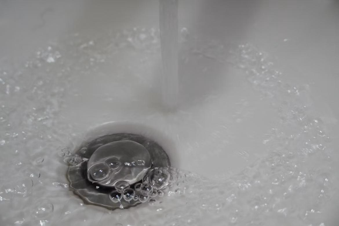 Plumbers identify slow drainage as an early warning sign of potential sewer line blockage or system deterioration