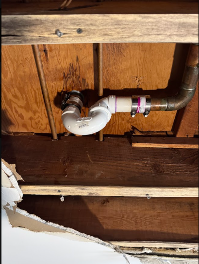 The trap under a kitchen cabinet, the first place a grease clog forms, but rarely the only place. Client Image: IMG_1439.jpeg