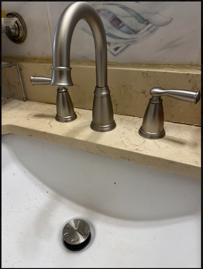 A vanity faucet, where aerator scale shows up long before the supply line is suspected.