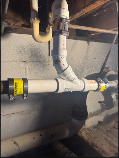 Mixed copper and PVC runs in a Long Island basement, where most early warning signs first show.