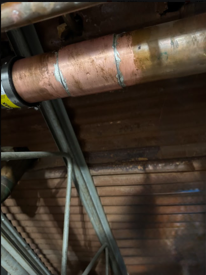 A failed section of copper cut out and repaired, the same work that follows a burst line.