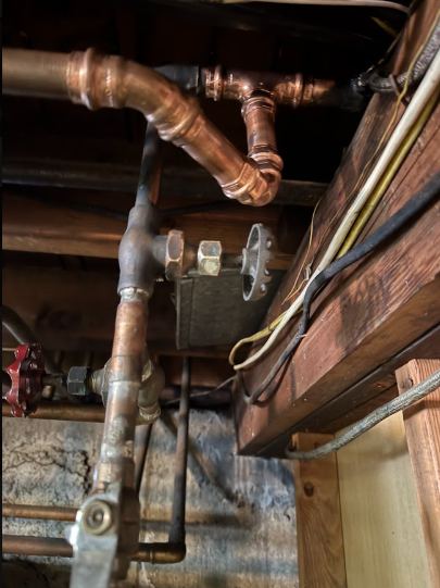 Rebuilt copper distribution after a failure, tested under pressure before the ceiling closes up.
