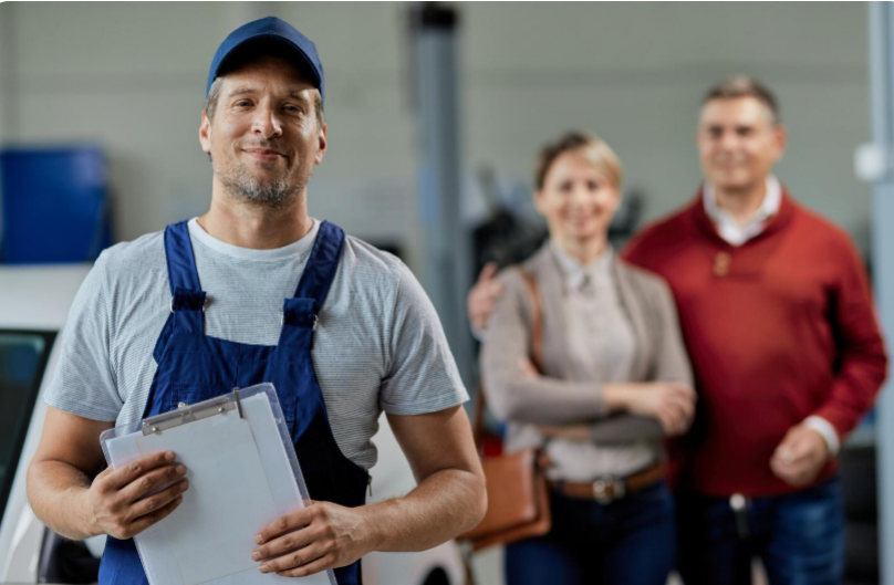Professional plumber with happy homeowners after completing plumbing service in Holtsville NY